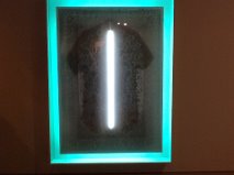 This was really cool. Although it's hard to make out in the picture the item of clothing almost had some sort of religious look to it. and the neon strip light was a lot thinner in reality. It looked like something out of a futuristic church. I really liked the minimalistic lighting and the aqua frame around the garment.